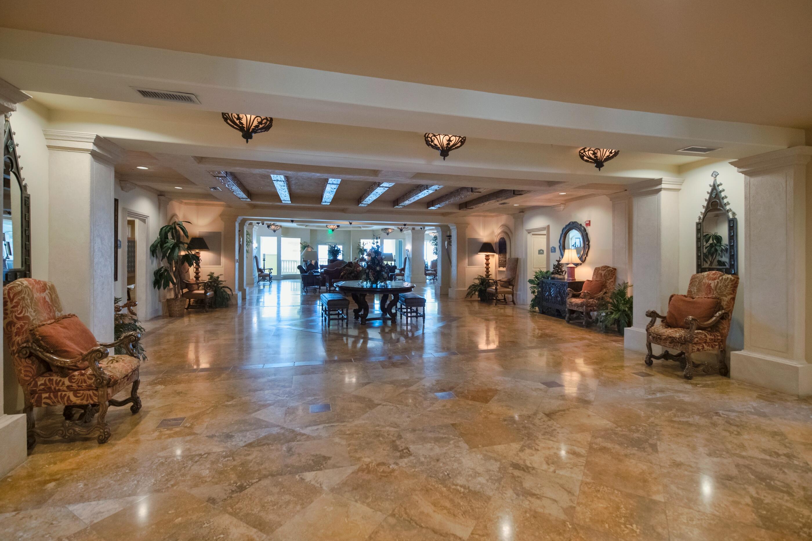 770 Harbor Boulevard, Unit 7E Destin, FL 32541 - Photo 36 of 38 a lobby with furniture and a glass top table