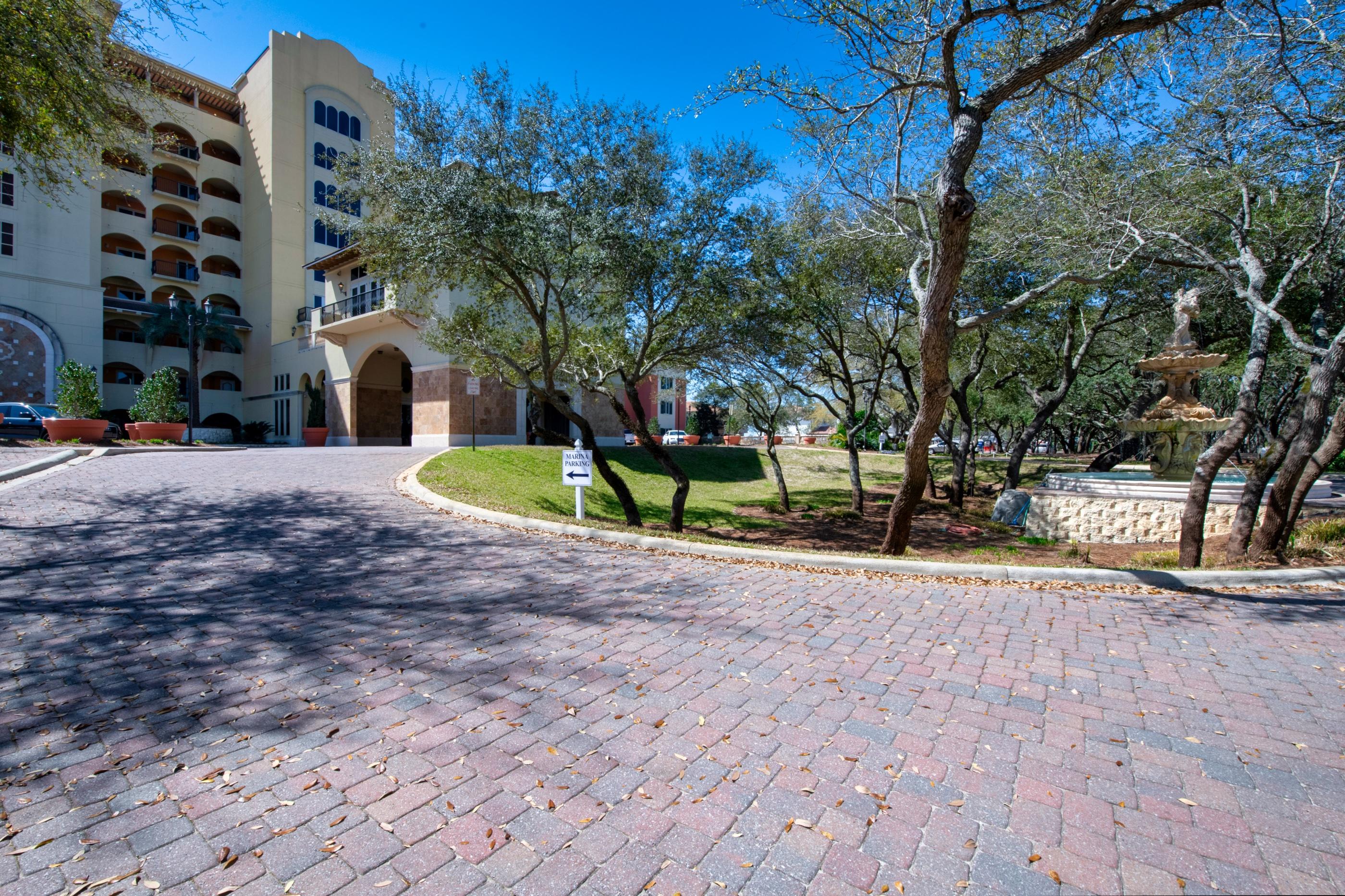 770 Harbor Boulevard, Unit 7E Destin, FL 32541 - Photo 38 of 38 a view of a brick house with a yard and large trees