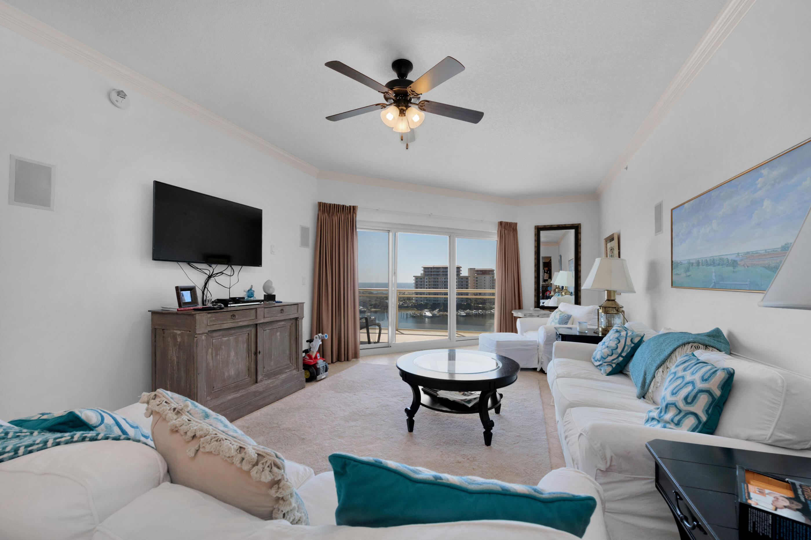 770 Harbor Boulevard, Unit 7E Destin, FL 32541 - Photo 4 of 38 a living room with furniture and a flat screen tv