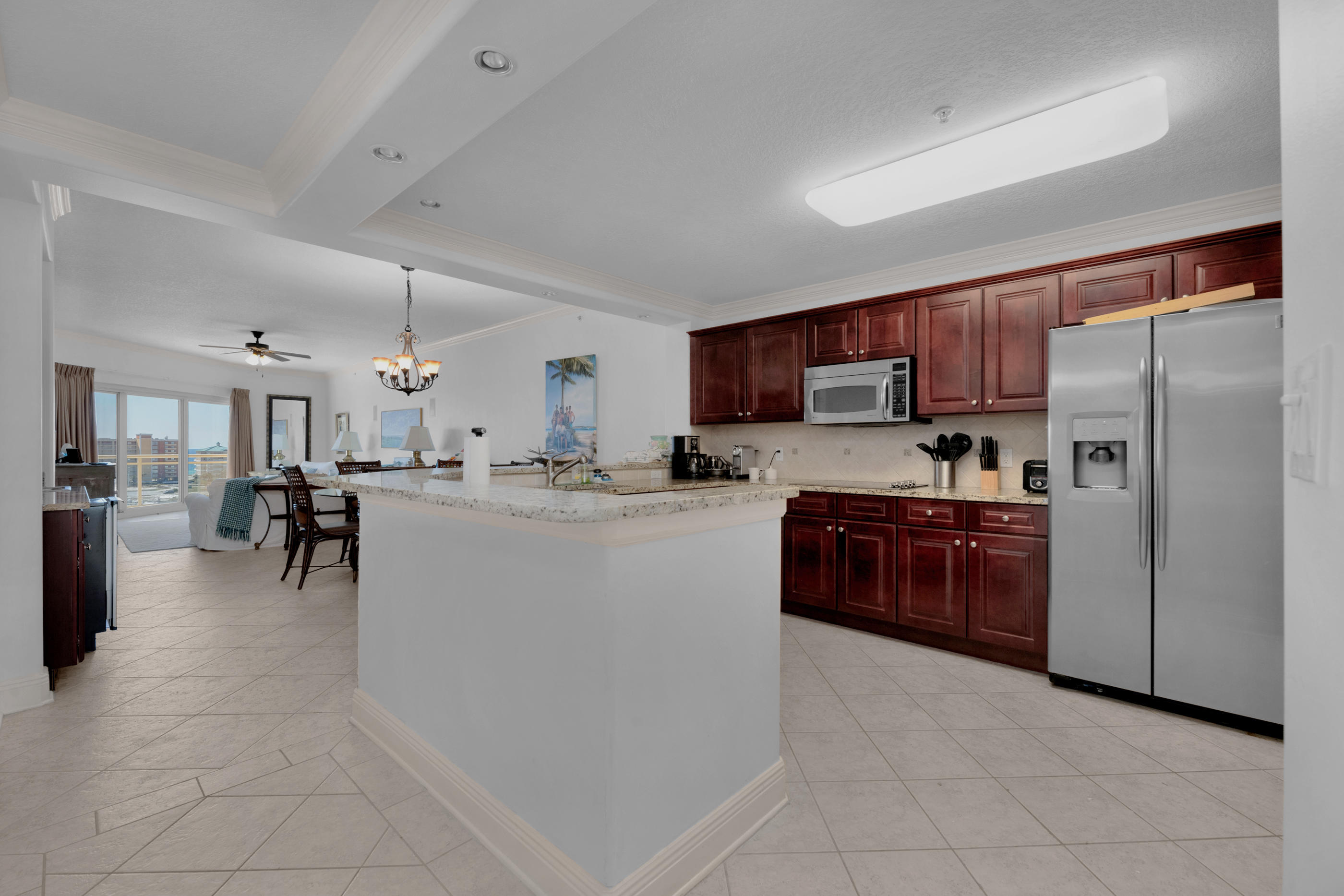 770 Harbor Boulevard, Unit 7E Destin, FL 32541 - Photo 6 of 38 a kitchen with granite countertop a refrigerator and a stove top oven