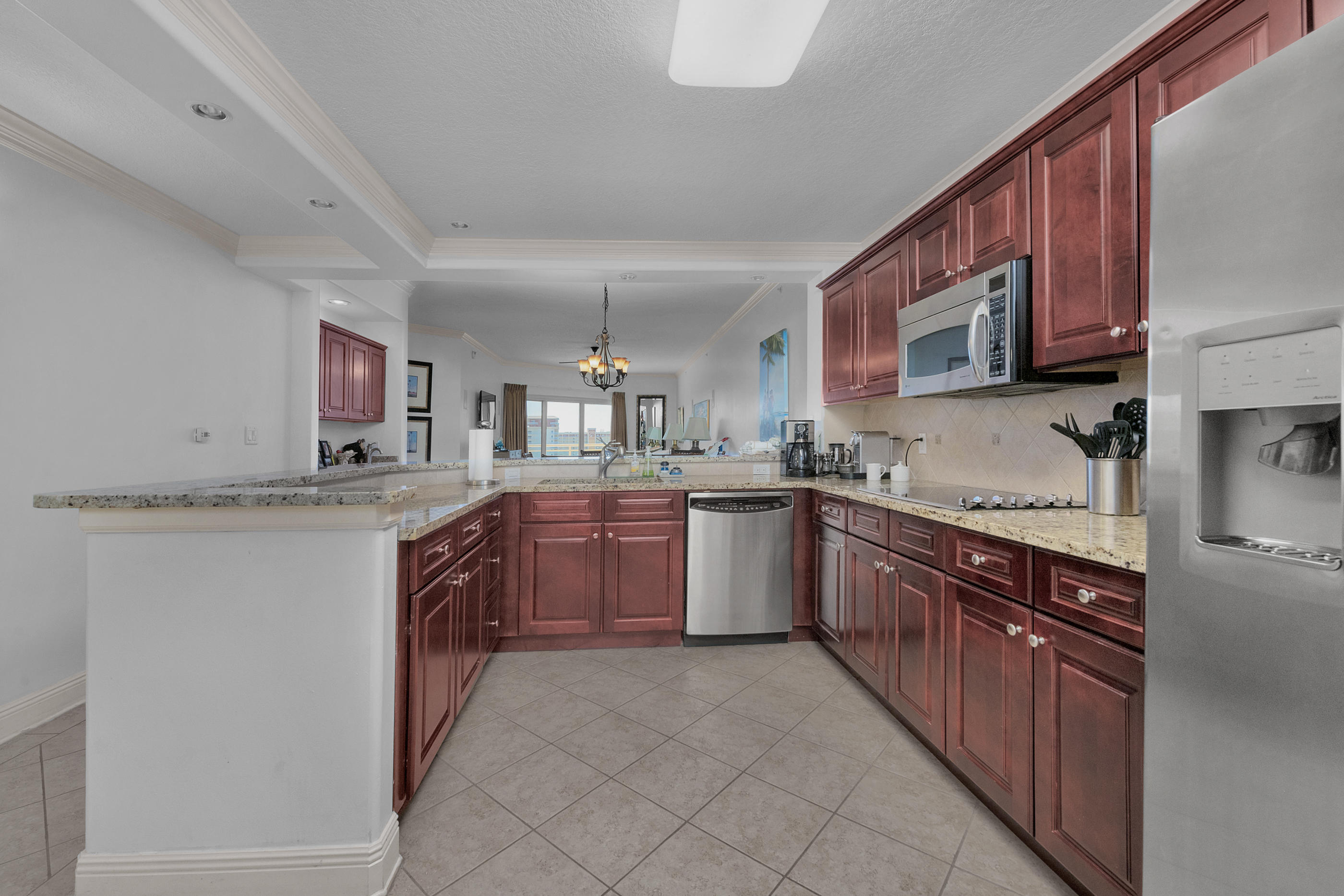 770 Harbor Boulevard, Unit 7E Destin, FL 32541 - Photo 7 of 38 a kitchen with stainless steel appliances granite countertop a sink stove and microwave