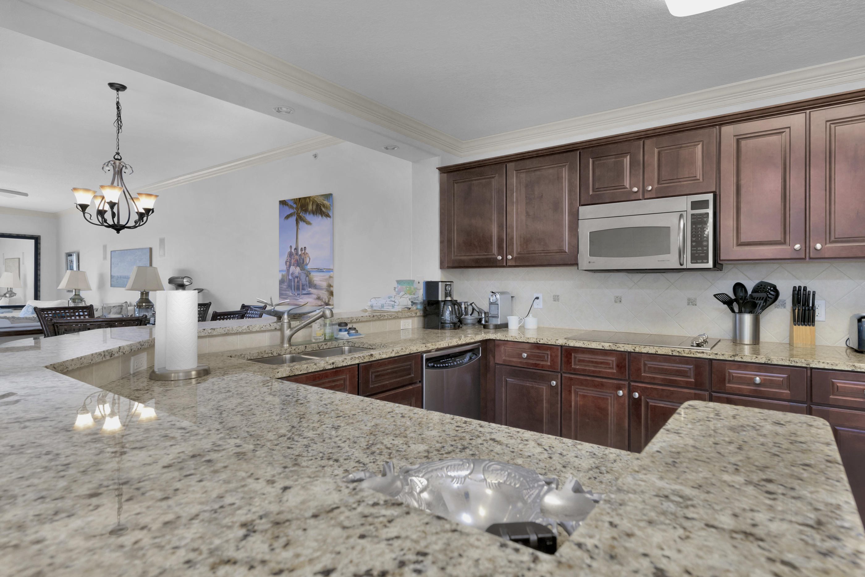 770 Harbor Boulevard, Unit 7E Destin, FL 32541 - Photo 9 of 38 a kitchen with stainless steel appliances granite countertop a sink dishwasher stove and cabinets