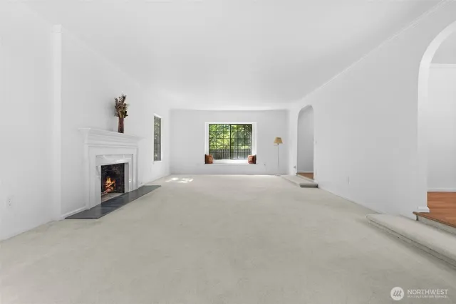 a view of a livingroom with a fireplace and window