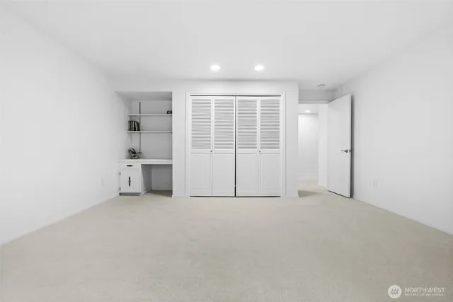 a white bath tub sitting next to a white sink and vanity