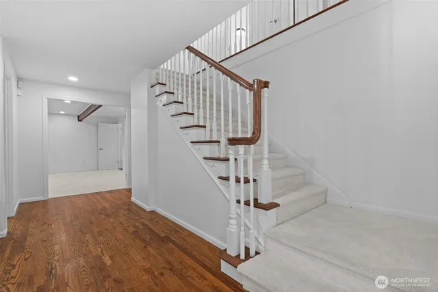 a view of entryway and hall with wooden floor