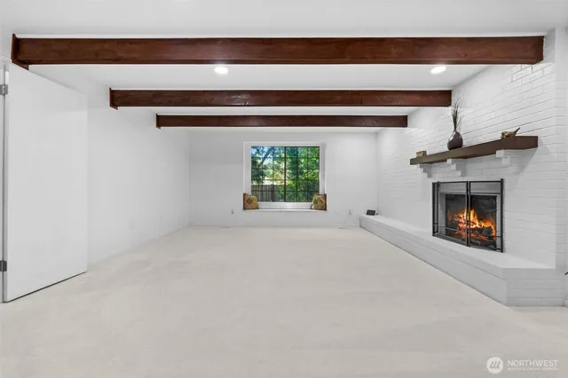 a view of empty room with a fireplace