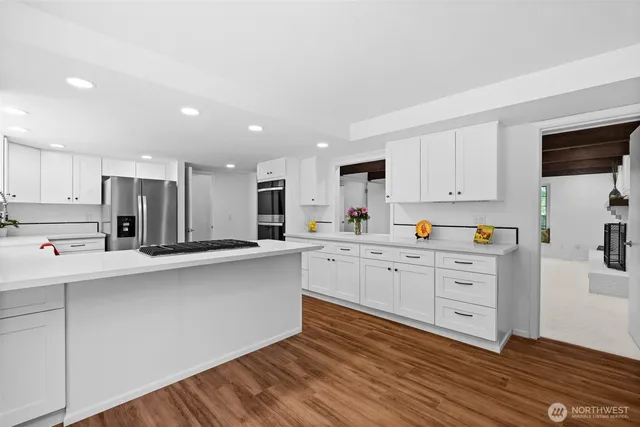 a kitchen with stainless steel appliances white cabinets and a sink