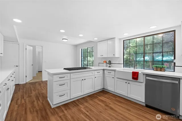a dining room with wooden floor a chandelier a glass table and chairs