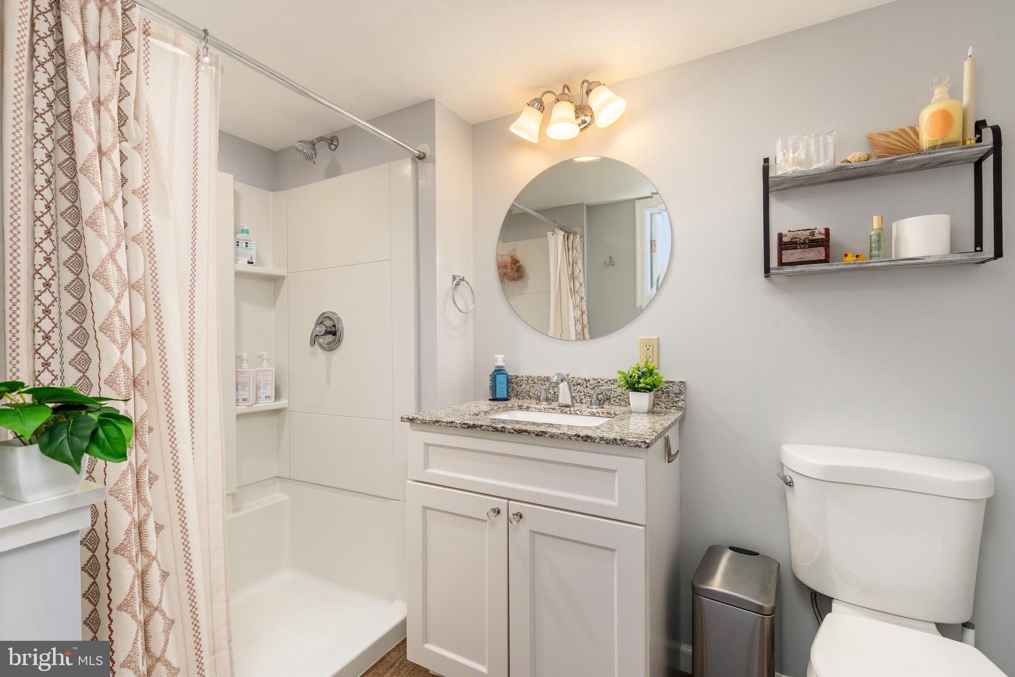 583 Lake Boulevard Lindenwold, NJ 08021 - Photo 41 of 51 a bathroom with a sink a toilet and a mirror