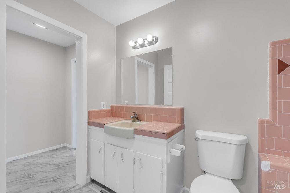 4785 Highway 12 Santa Rosa, CA 95409 - Photo 26 of 80 a bathroom with a toilet sink and mirror