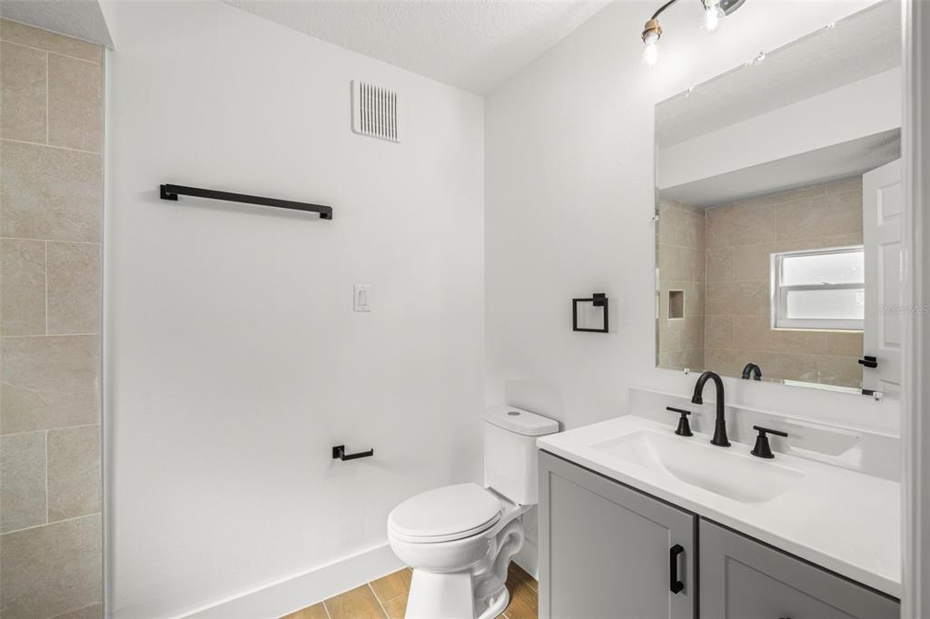 8082 Pagoda Drive Spring Hill, FL 34606 - Photo 15 of 28 a bathroom with a sink toilet and a mirror