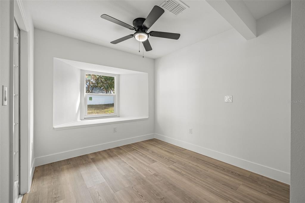 8082 Pagoda Drive Spring Hill, FL 34606 - Photo 17 of 28 an empty room with a window and a ceiling fan