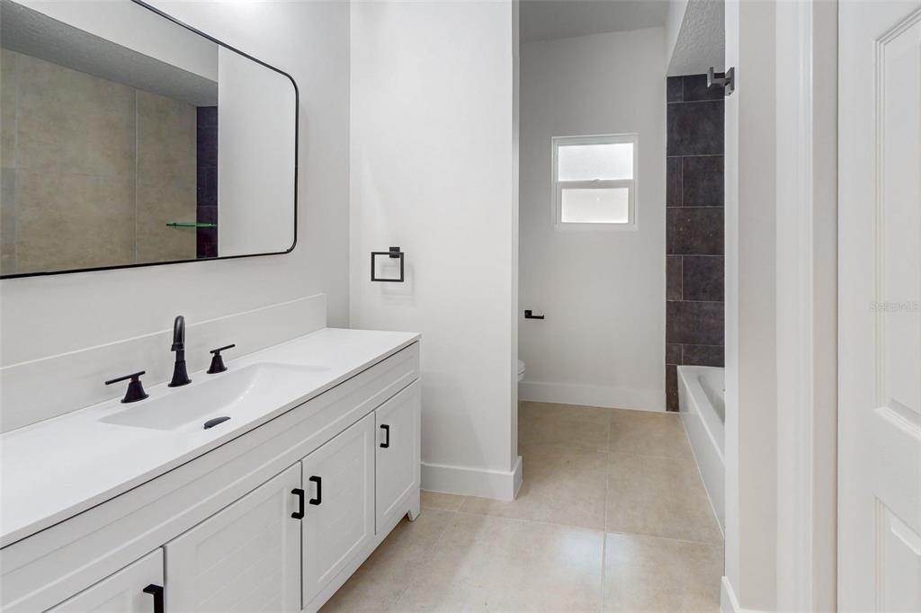 8082 Pagoda Drive Spring Hill, FL 34606 - Photo 19 of 28 a bathroom with a double vanity sink mirror and