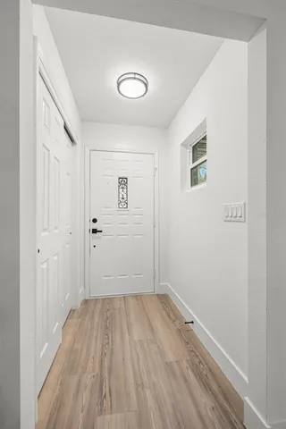 a view of a room with wooden floor