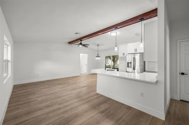 a view of kitchen with cabinets and wooden floor