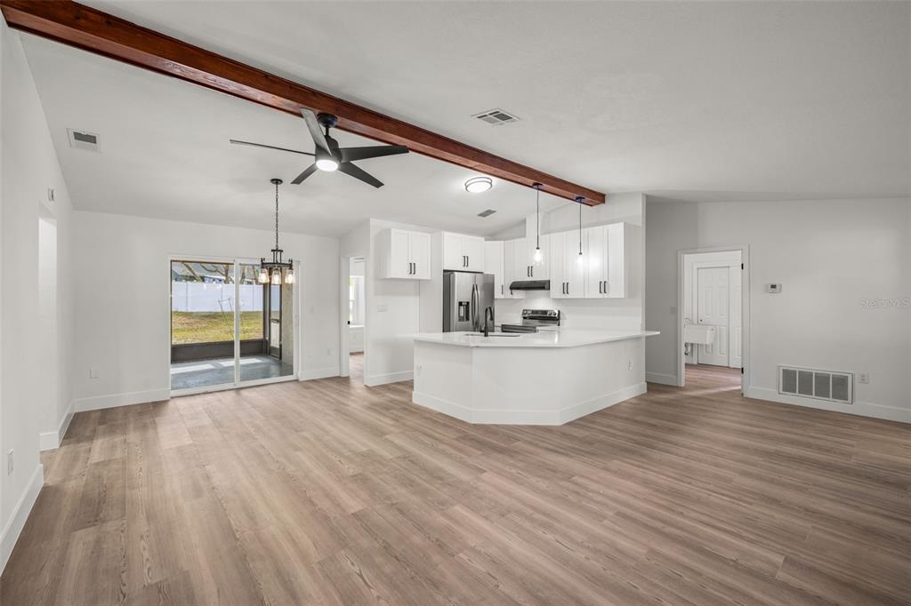 8082 Pagoda Drive Spring Hill, FL 34606 - Photo 5 of 28 a view of a kitchen with wooden floor and windows