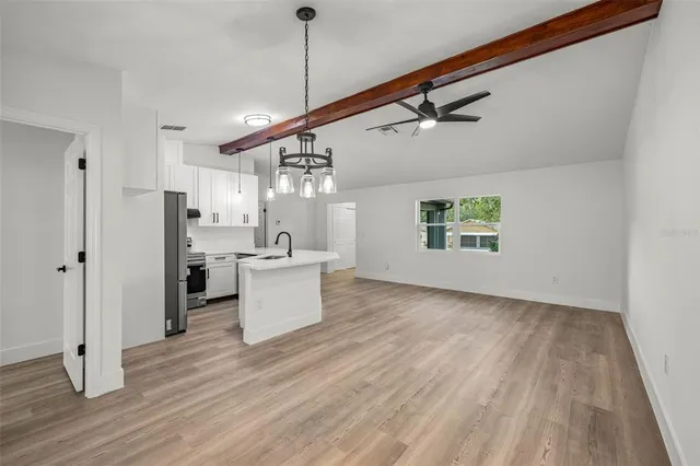 a view of a kitchen with a sink and wooden floor