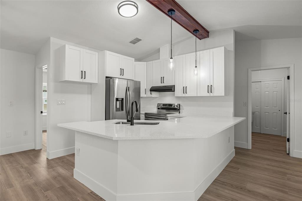 8082 Pagoda Drive Spring Hill, FL 34606 - Photo 8 of 28 a kitchen with kitchen island a white counter top space cabinets and stainless steel appliances