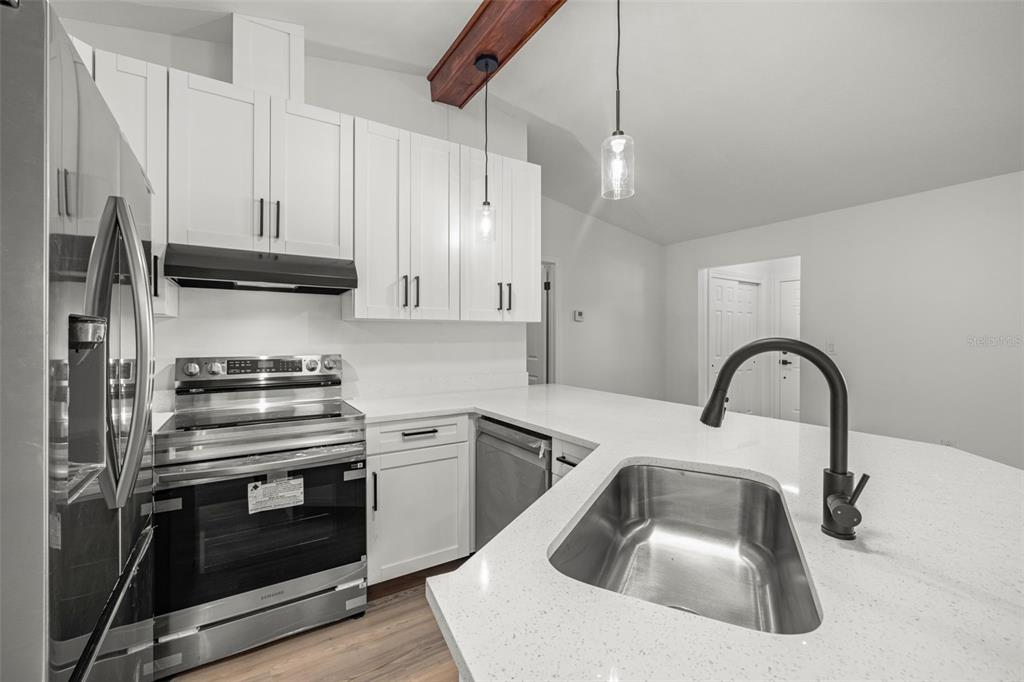 8082 Pagoda Drive Spring Hill, FL 34606 - Photo 9 of 28 a kitchen with granite countertop a sink stainless steel appliances and cabinets