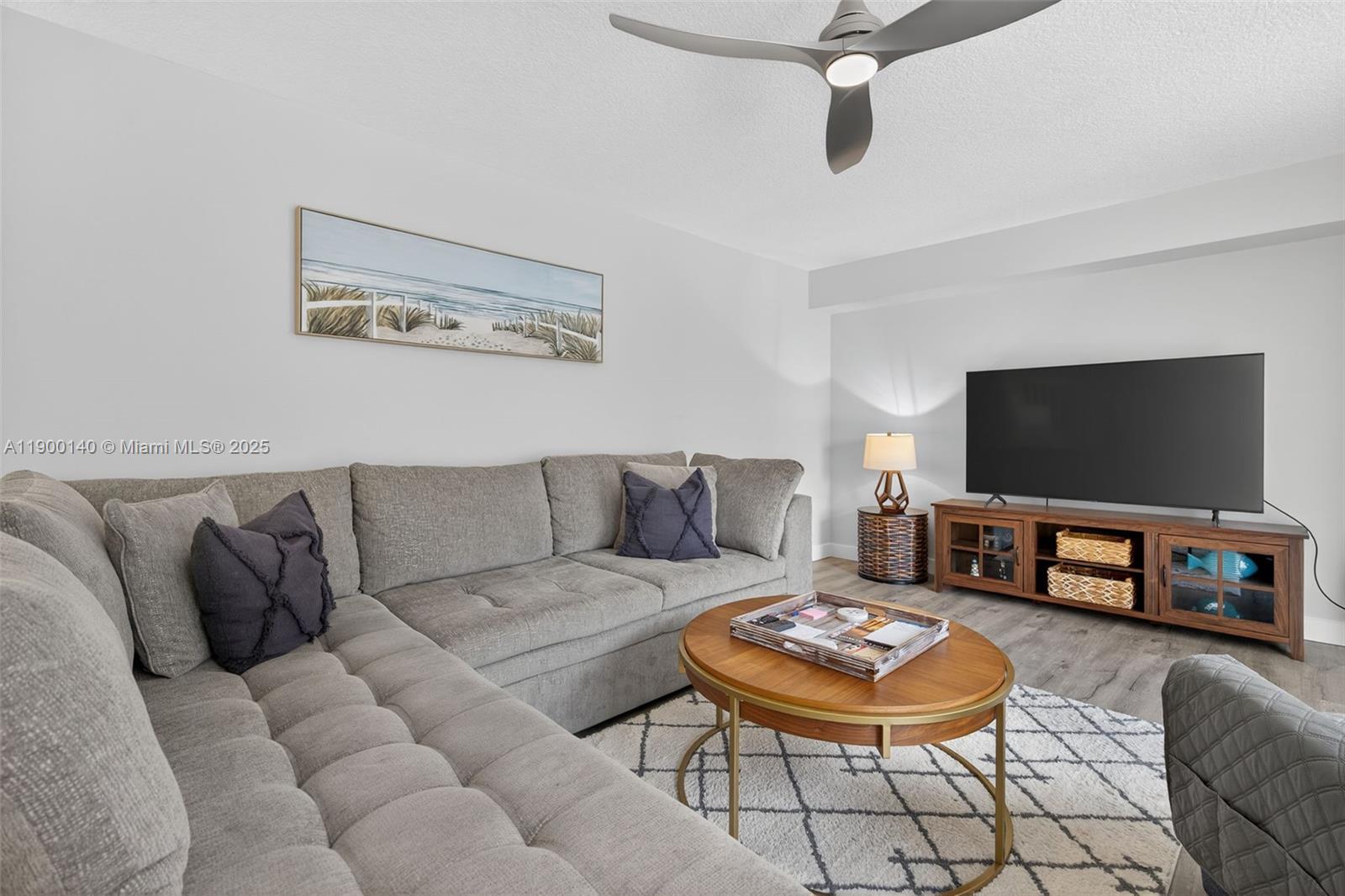 2701 27th Court, Unit 2701 Jupiter, FL 33477 - Photo 12 of 28 a living room with furniture and a flat screen tv