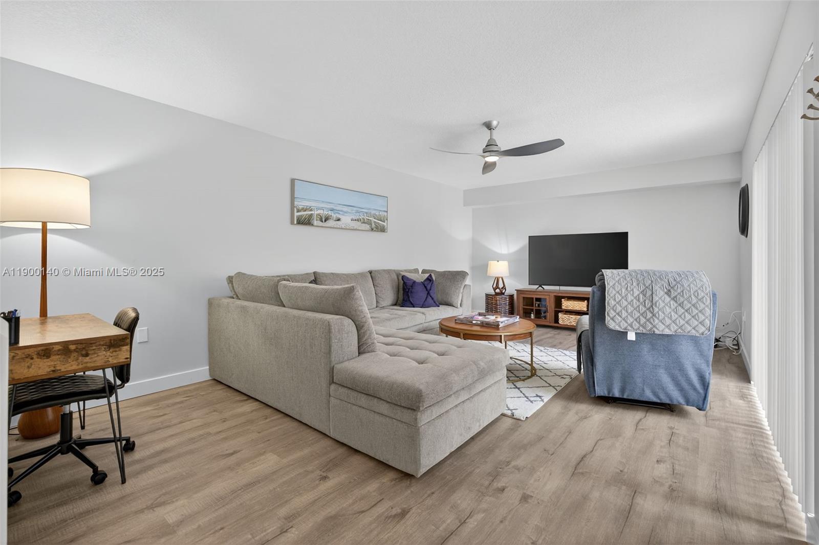 2701 27th Court, Unit 2701 Jupiter, FL 33477 - Photo 13 of 28 a living room with furniture and a wooden floor