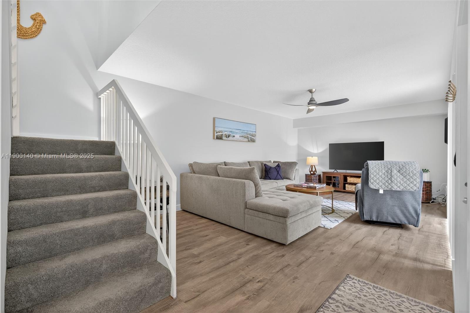 2701 27th Court, Unit 2701 Jupiter, FL 33477 - Photo 14 of 28 a living room with furniture and a flat screen tv