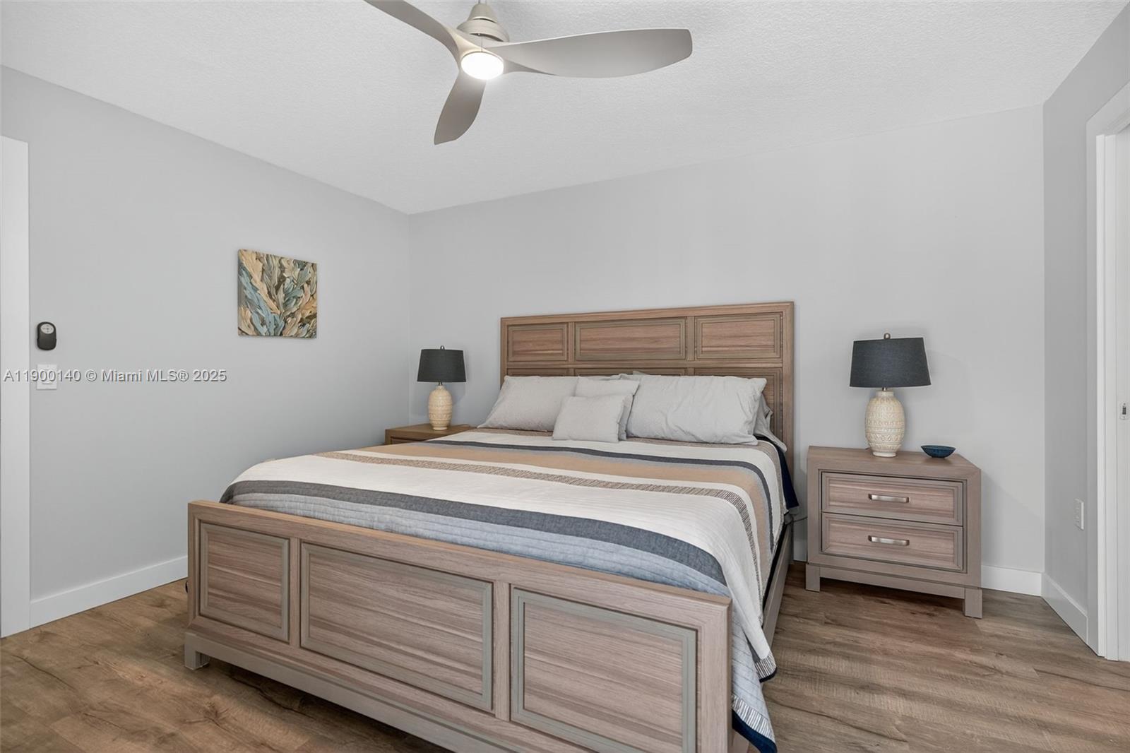 2701 27th Court, Unit 2701 Jupiter, FL 33477 - Photo 15 of 28 a bedroom with a bed and a lamp