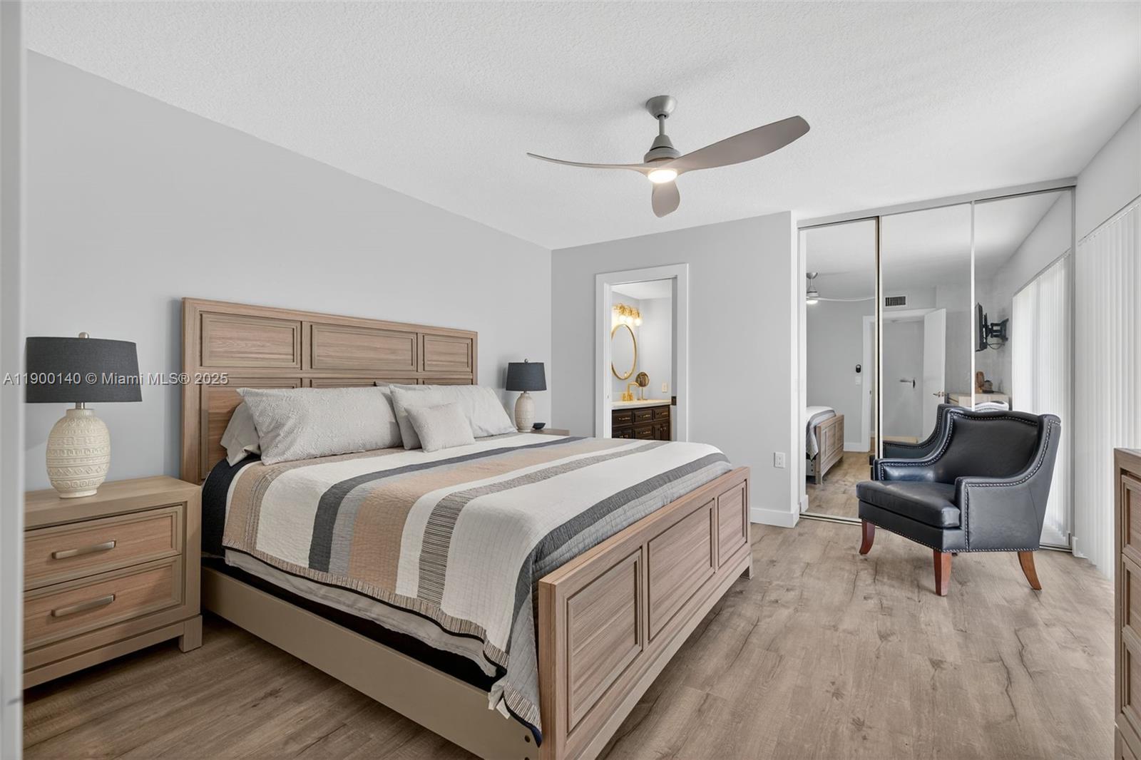 2701 27th Court, Unit 2701 Jupiter, FL 33477 - Photo 16 of 28 a bed room with a bed and a chair