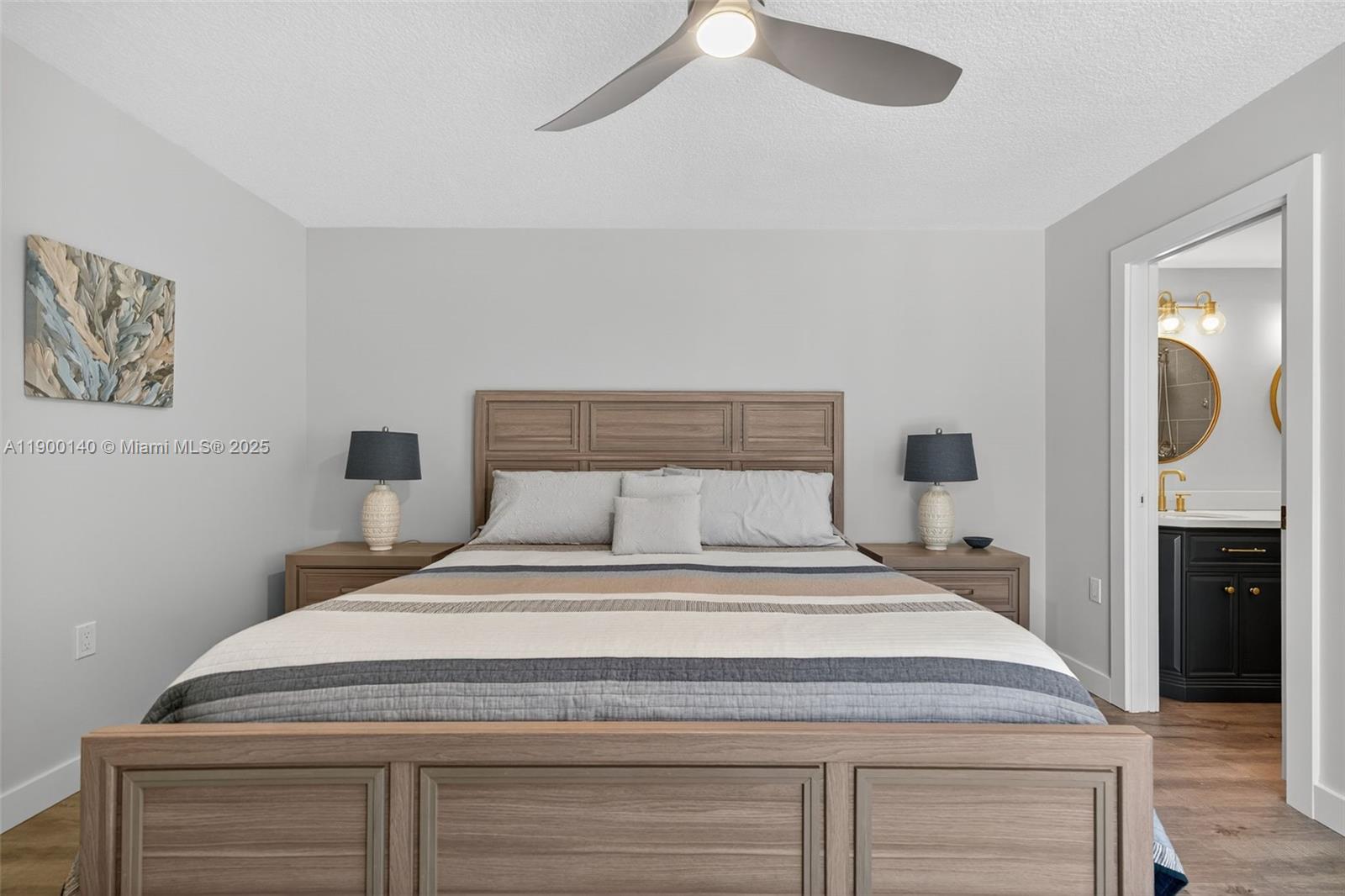 2701 27th Court, Unit 2701 Jupiter, FL 33477 - Photo 17 of 28 a bedroom with a bed and a chandelier