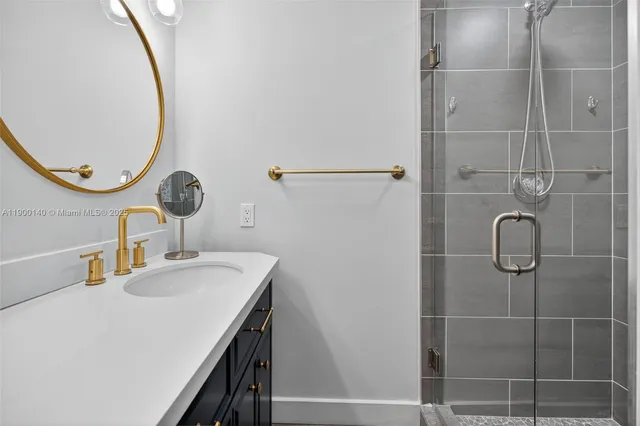 a bathroom with a sink vanity and a mirror