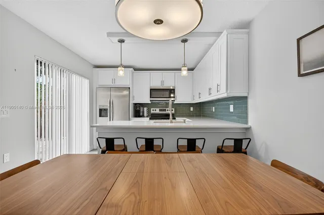 a large kitchen with stainless steel appliances a large center island in it