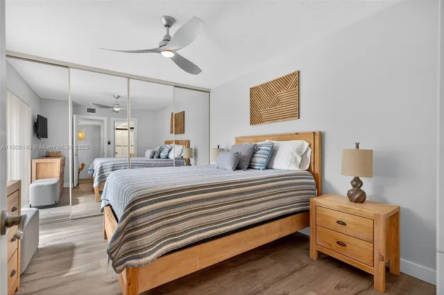 a bedroom with bed and a chandelier