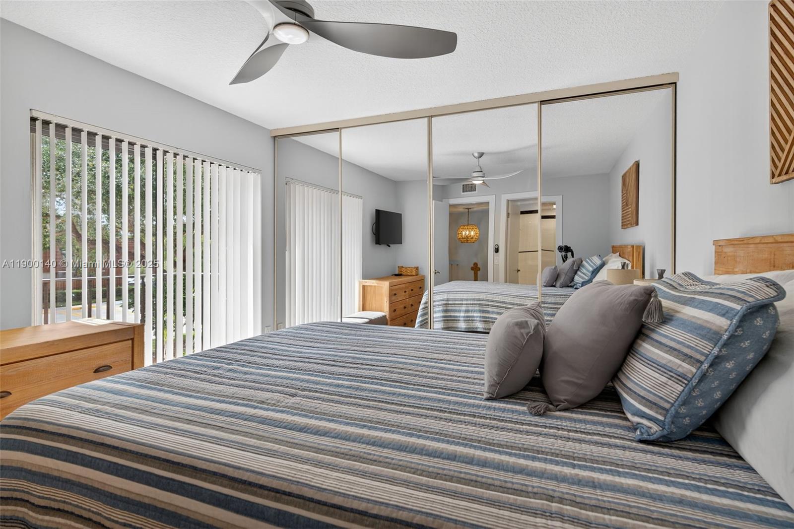 2701 27th Court, Unit 2701 Jupiter, FL 33477 - Photo 23 of 28 a bedroom with a bed window and walk in closet