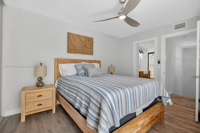 a bedroom with bed and wooden floor