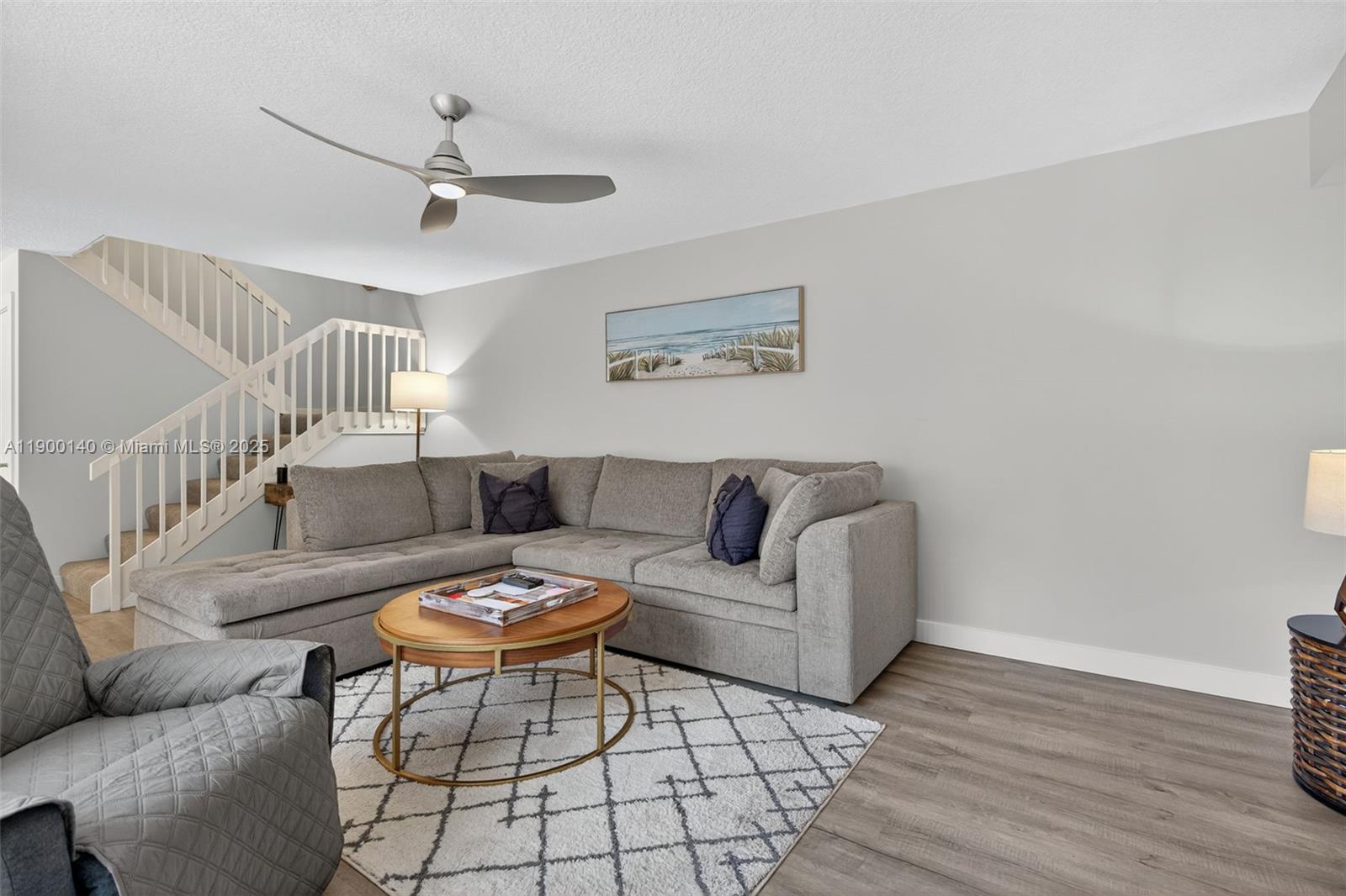 2701 27th Court, Unit 2701 Jupiter, FL 33477 - Photo 7 of 28 a living room with furniture and a wooden floor
