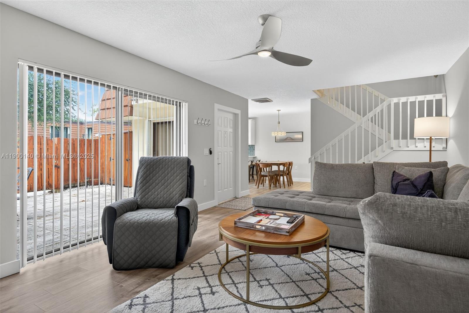 2701 27th Court, Unit 2701 Jupiter, FL 33477 - Photo 8 of 28 a living room with furniture and a large window