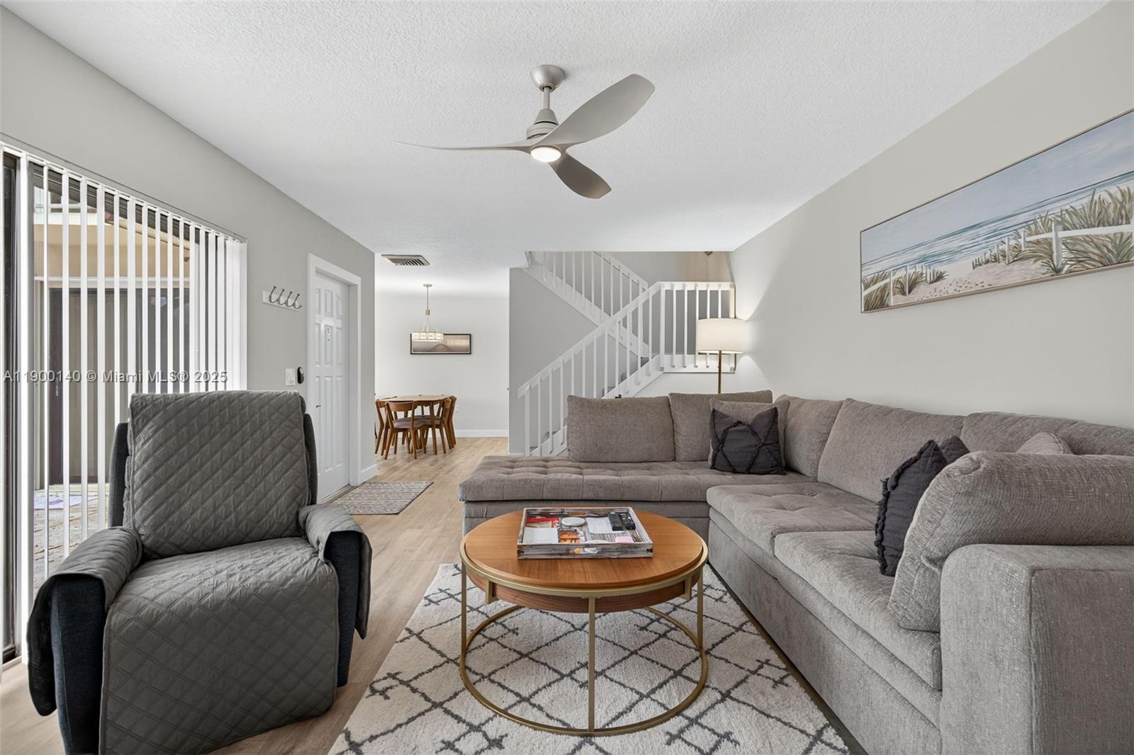 2701 27th Court, Unit 2701 Jupiter, FL 33477 - Photo 9 of 28 a living room with furniture and a wooden floor