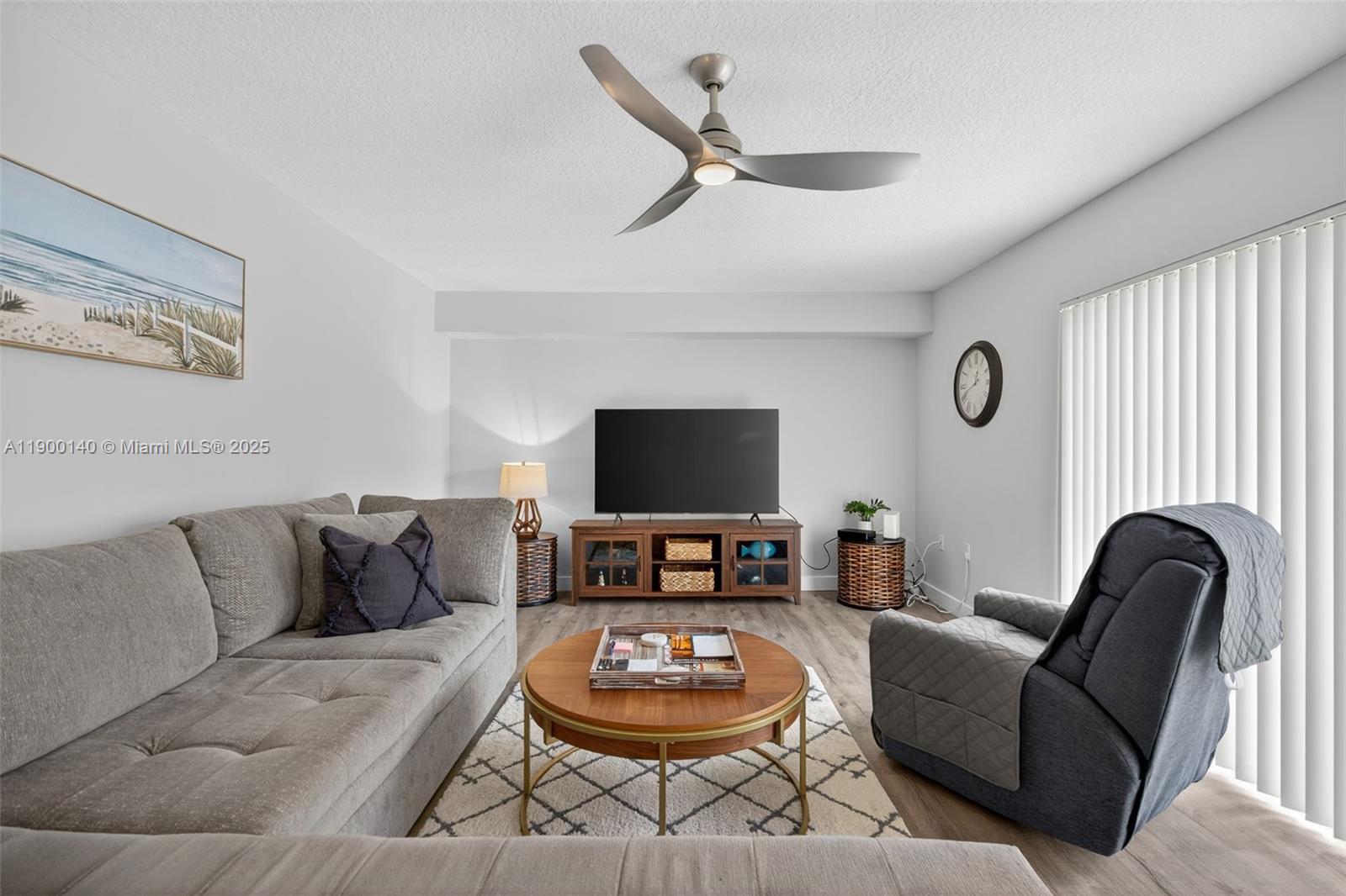 2701 27th Court, Unit 2701 Jupiter, FL 33477 - Photo 10 of 28 a living room with furniture and a flat screen tv