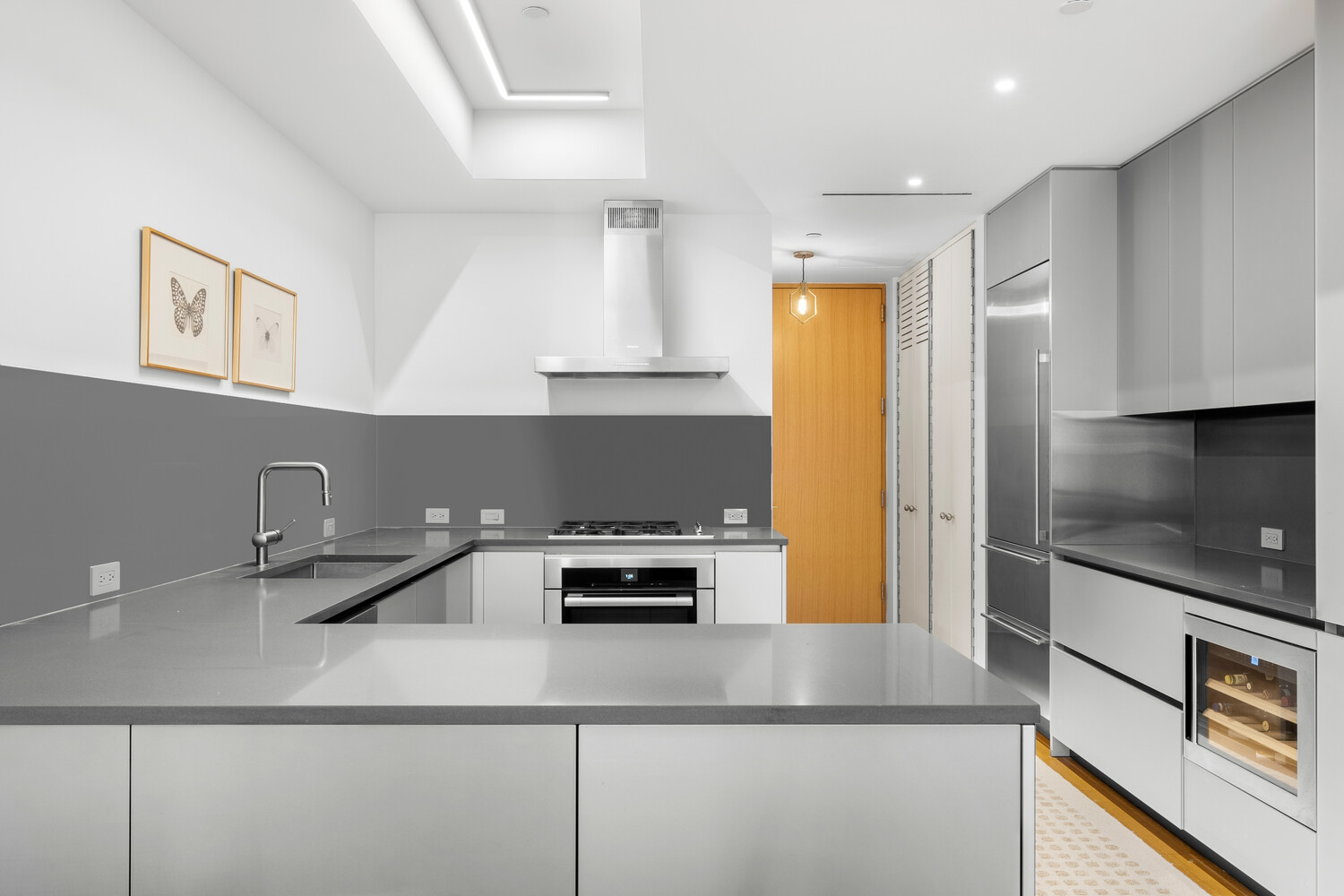 a kitchen with a sink a stove and cabinets