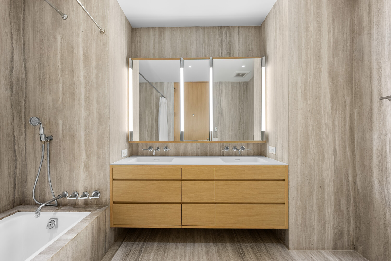 71 Reade Street, Unit 4C Manhattan, NY 10007 - Photo 8 of 12 a bathroom with a double vanity sink a mirror and a bathtub