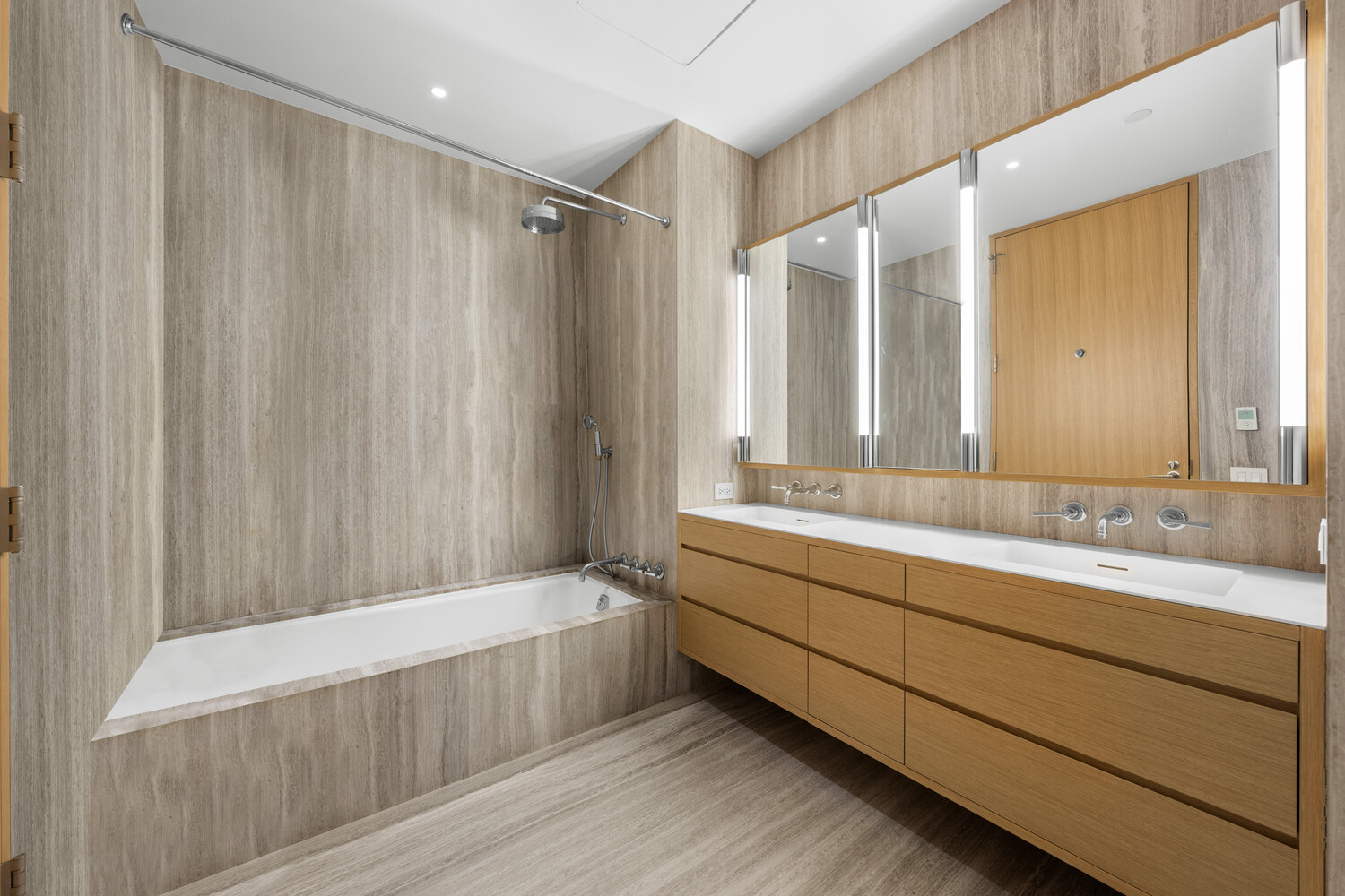 71 Reade Street, Unit 4C Manhattan, NY 10007 - Photo 9 of 12 a bathroom with a tub a sink and mirrors