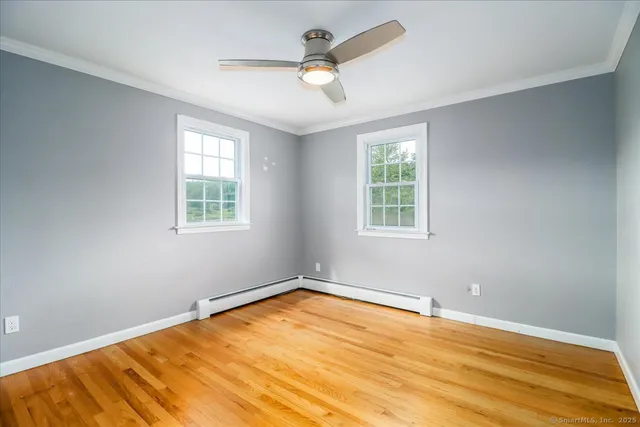 wooden floor in an empty room with a window