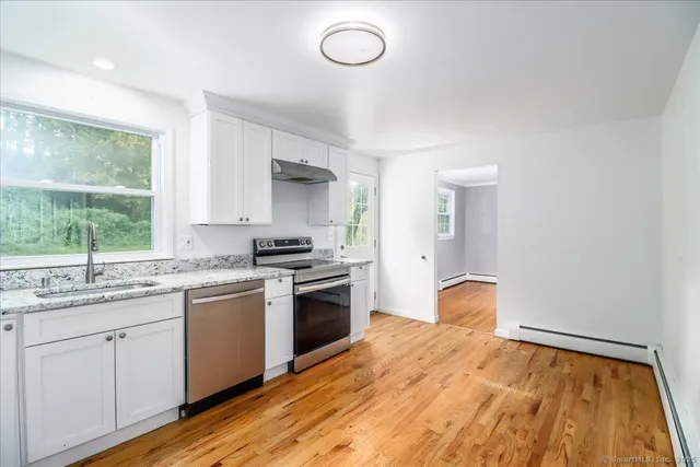 a kitchen with a sink stove and cabinets