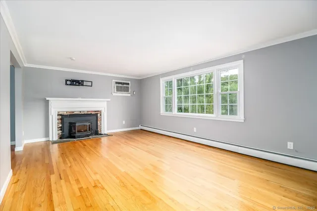 a view of empty room with a fireplace