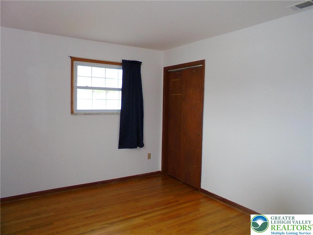 1217 Salisbury Road Allentown, PA 18103 - Photo 12 of 21 a view of an empty room with wooden floor and a window
