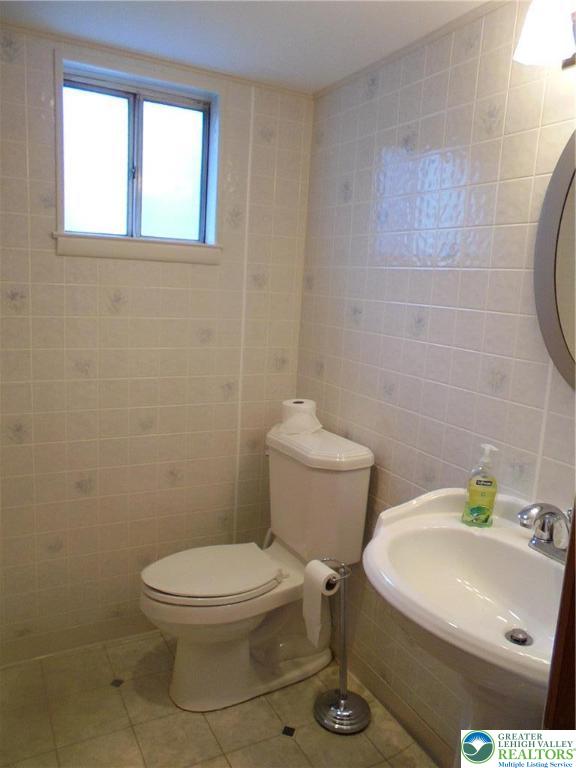 1217 Salisbury Road Allentown, PA 18103 - Photo 17 of 21 a white toilet sitting next to a bathroom sink