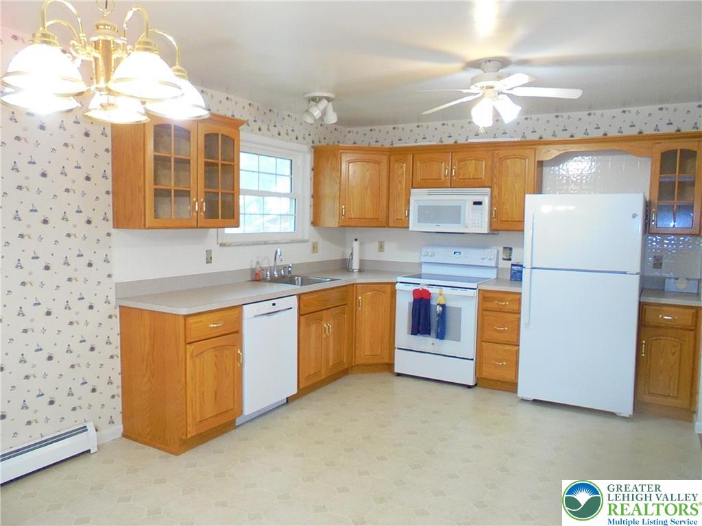 1217 Salisbury Road Allentown, PA 18103 - Photo 6 of 21 a kitchen with stainless steel appliances granite countertop a stove a sink and a refrigerator