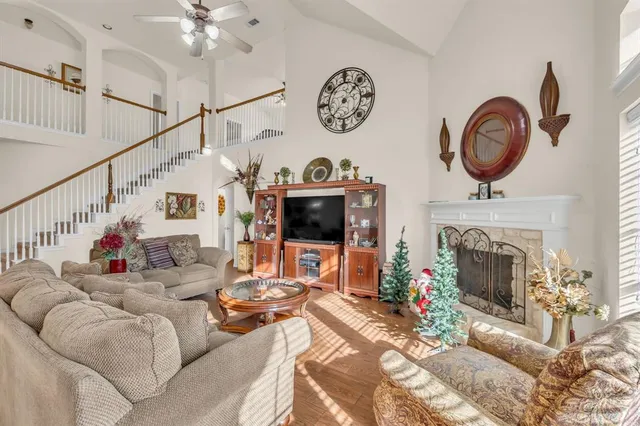 a living room with furniture a fireplace and a flat screen tv