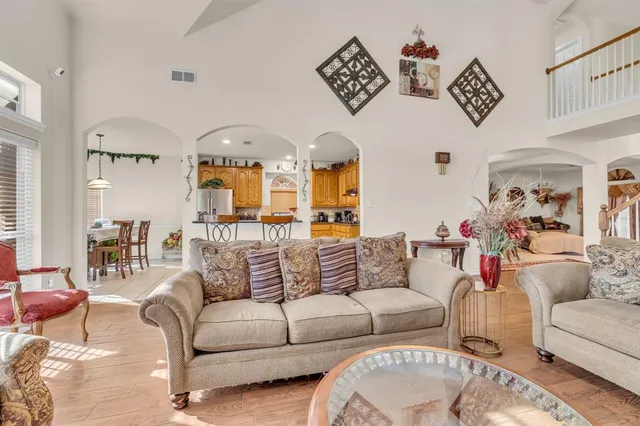 a living room with furniture and a chandelier