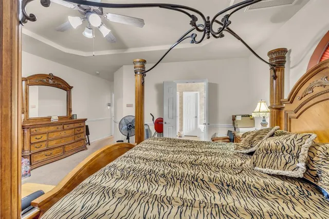 a bed room with a bed and a chandelier